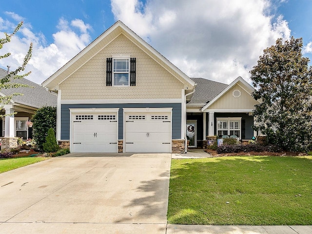 craftsman-style house featuring a garage and a front lawn