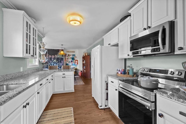 kitchen featuring stainless steel appliances, light stone countertops, white cabinets, and dark hardwood / wood-style flooring