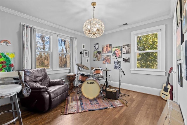 playroom featuring hardwood / wood-style flooring, ornamental molding, and an inviting chandelier