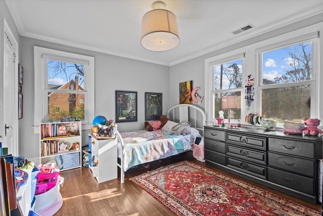 bedroom featuring multiple windows, ornamental molding, and dark wood-type flooring