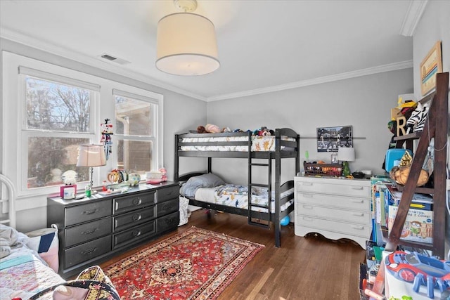 bedroom featuring ornamental molding and dark hardwood / wood-style floors