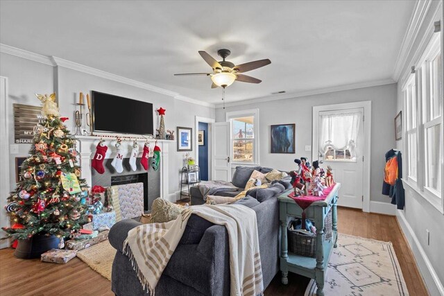 living room featuring ornamental molding, hardwood / wood-style floors, and ceiling fan