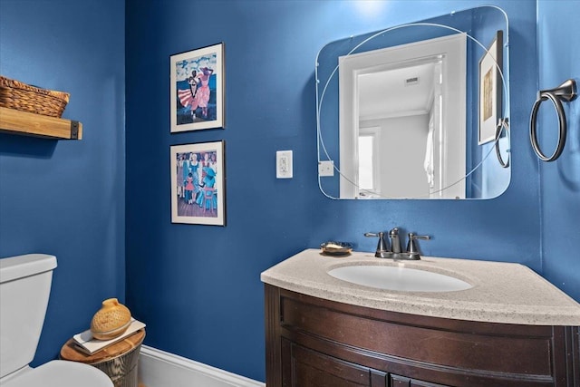 bathroom featuring vanity and toilet