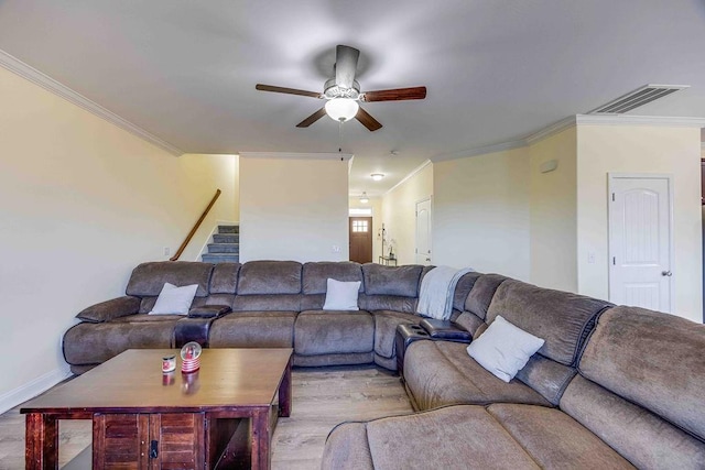 living room with light wood-type flooring, ceiling fan, and crown molding