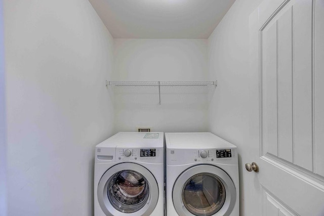 laundry area with washing machine and dryer