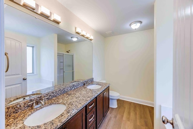 full bathroom featuring vanity, plus walk in shower, wood-type flooring, and toilet