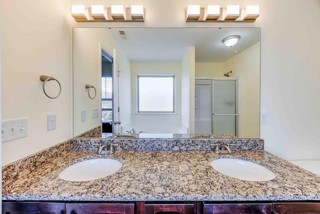 bathroom featuring plus walk in shower and vanity