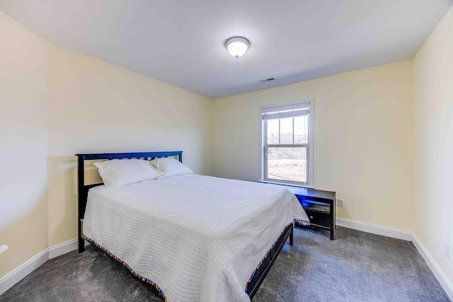 bedroom with dark colored carpet