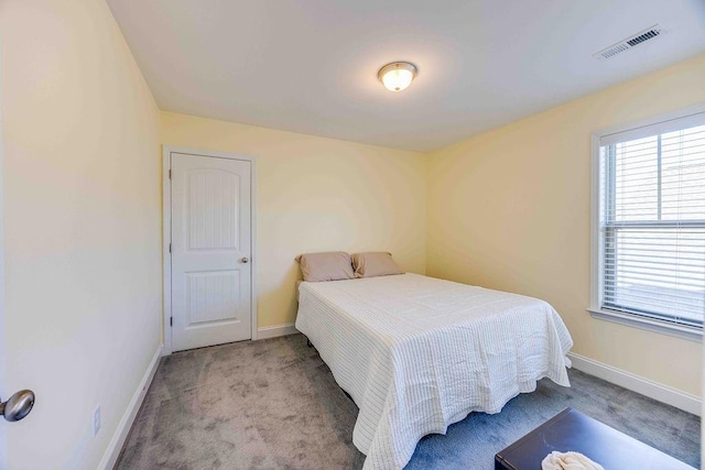 bedroom featuring light carpet