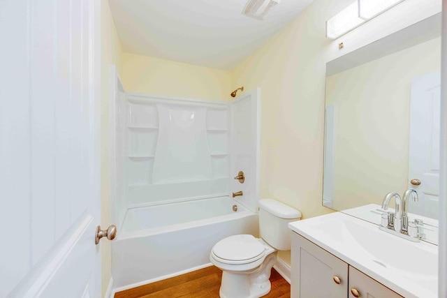 full bathroom with shower / bath combination, vanity, wood-type flooring, and toilet