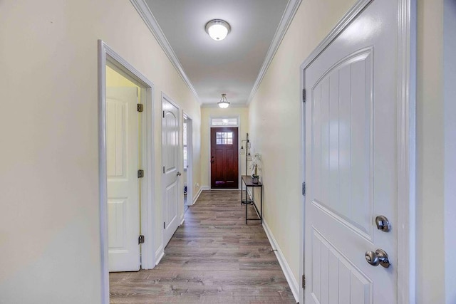 doorway to outside featuring light wood-type flooring and crown molding