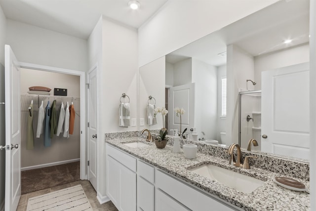 bathroom featuring vanity, toilet, and walk in shower