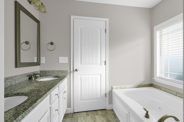 bathroom with a tub and vanity