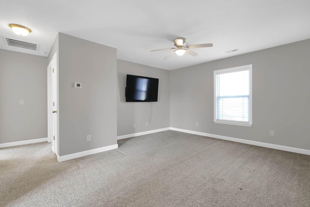 empty room featuring carpet floors and ceiling fan