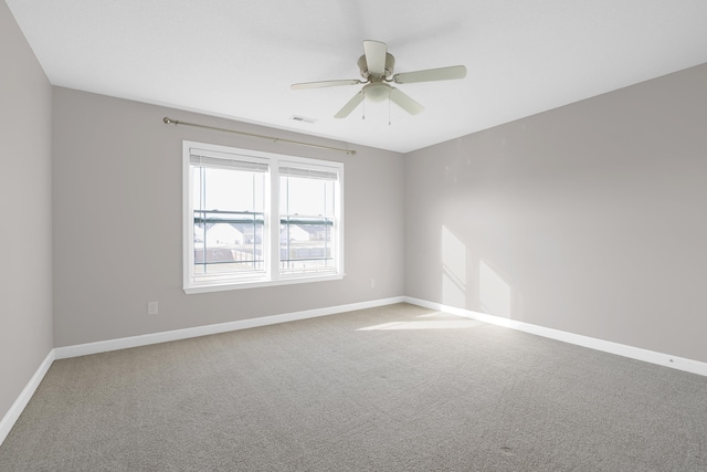 spare room with carpet floors and ceiling fan