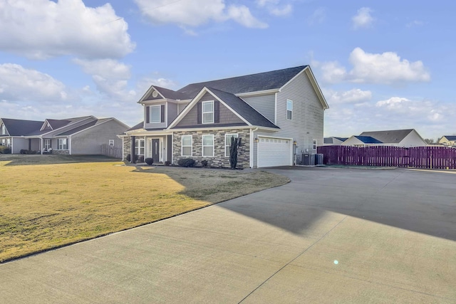 view of front of property featuring central AC, a front lawn, and a garage