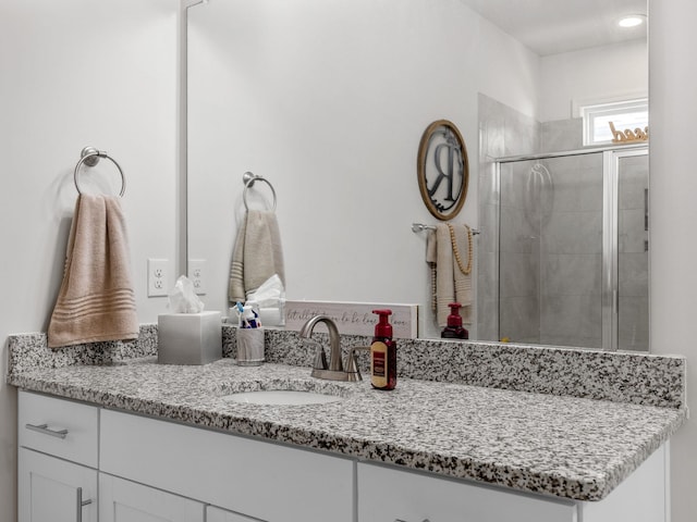 bathroom with vanity and walk in shower