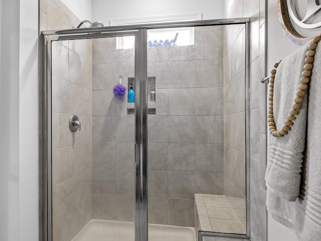 bathroom featuring a shower with shower door