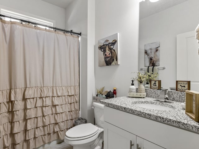 bathroom with walk in shower, vanity, and toilet