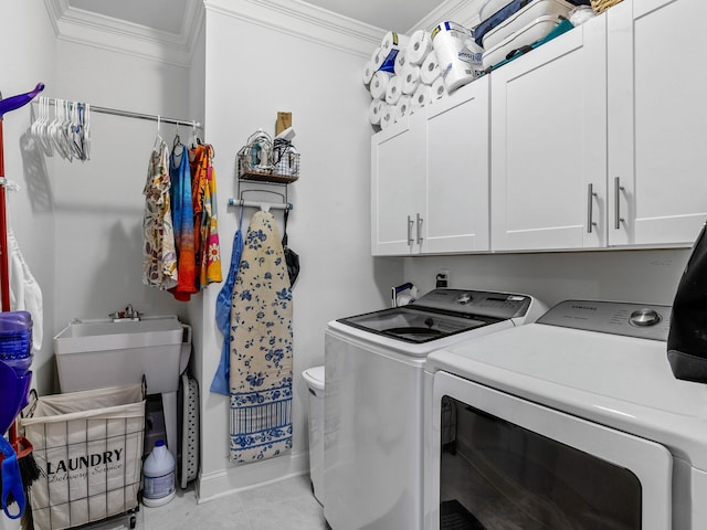 laundry room with washer and dryer, ornamental molding, cabinets, and light tile patterned flooring