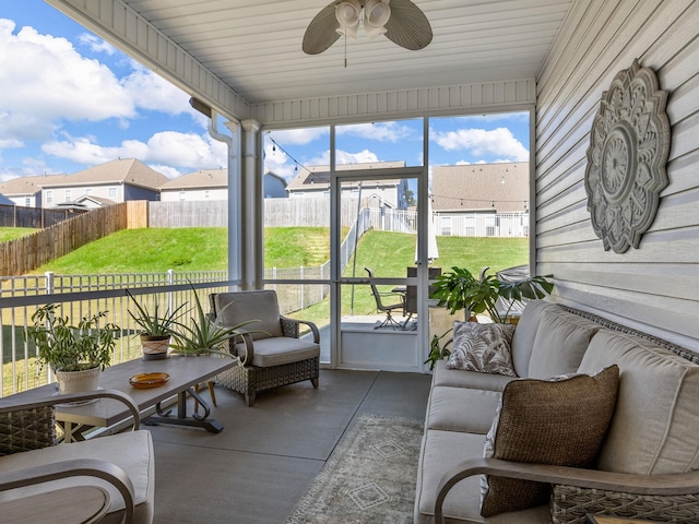 sunroom / solarium featuring ceiling fan