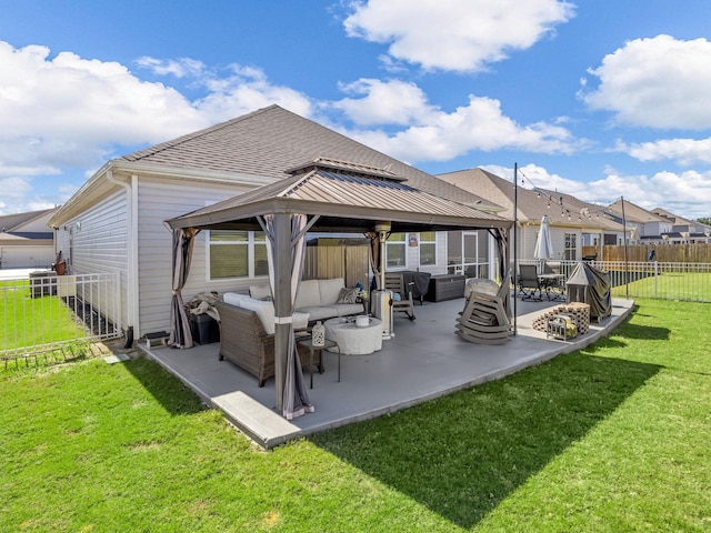 back of house with a gazebo, an outdoor living space, and a lawn