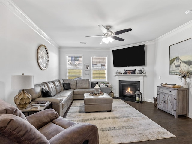 living room with ceiling fan, ornamental molding, and dark wood-type flooring