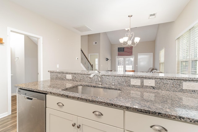 kitchen with dishwasher, an inviting chandelier, sink, hanging light fixtures, and stone countertops