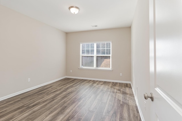 unfurnished room with hardwood / wood-style flooring