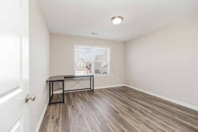 spare room with hardwood / wood-style floors