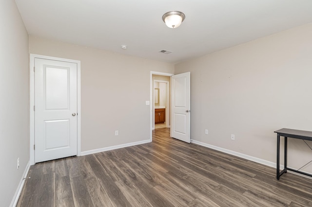 unfurnished room with dark hardwood / wood-style floors