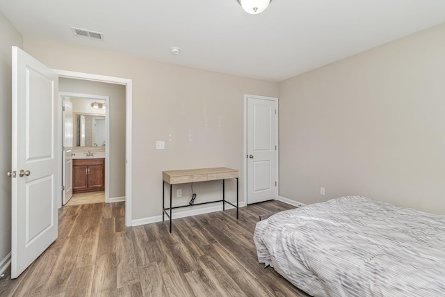 bedroom featuring dark hardwood / wood-style floors and sink