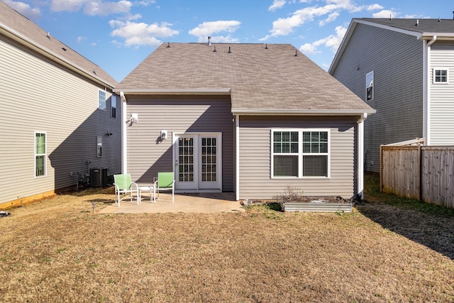 back of property with a lawn, a patio area, and central AC unit