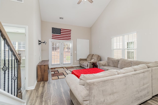 living room with ceiling fan, hardwood / wood-style floors, and high vaulted ceiling