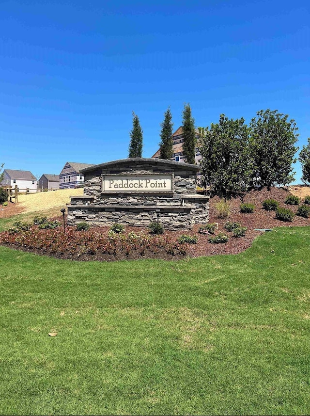 community / neighborhood sign with a yard