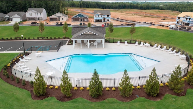 view of pool with a lawn and a patio