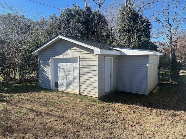 view of outbuilding featuring a yard and a garage