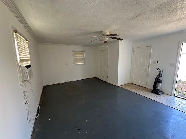 empty room featuring ceiling fan, cooling unit, and a textured ceiling