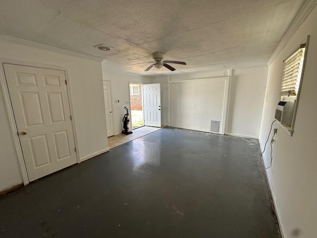 interior space with ceiling fan, crown molding, cooling unit, concrete flooring, and a textured ceiling