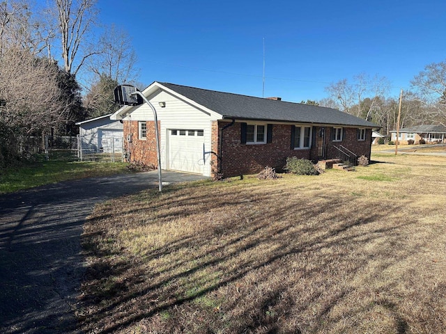 exterior space featuring a front yard, a garage, and central air condition unit