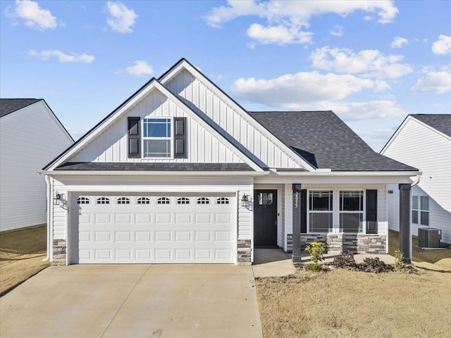 view of front of house with covered porch, central AC unit, and a garage