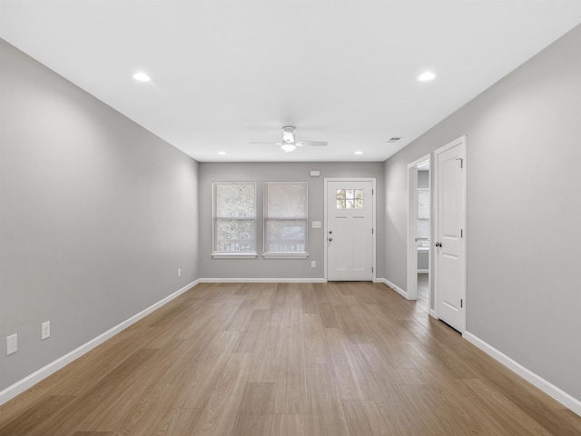 foyer with ceiling fan and light hardwood / wood-style flooring