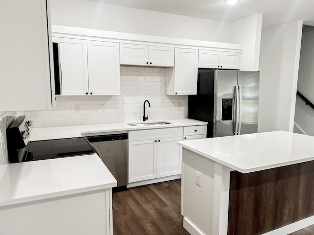 kitchen featuring white cabinetry, sink, a center island, dark hardwood / wood-style floors, and appliances with stainless steel finishes