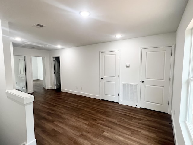 spare room with dark wood-type flooring