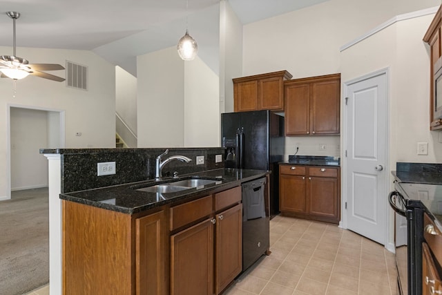 kitchen with dark stone counters, black appliances, sink, vaulted ceiling, and ceiling fan