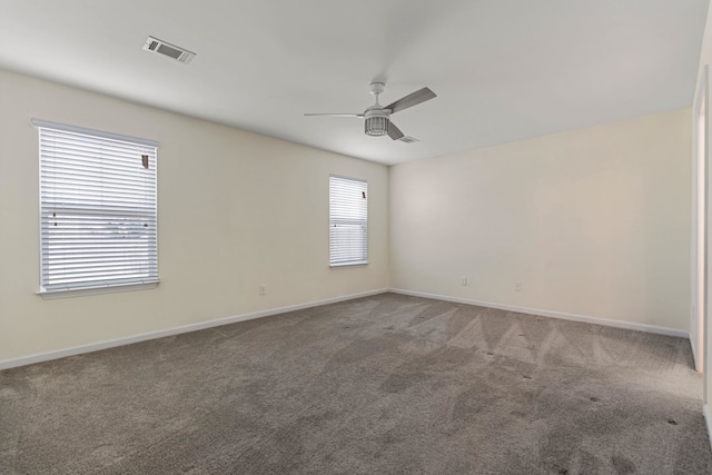 empty room featuring carpet flooring and ceiling fan