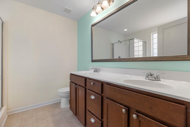 bathroom featuring tile patterned flooring, toilet, vanity, and walk in shower