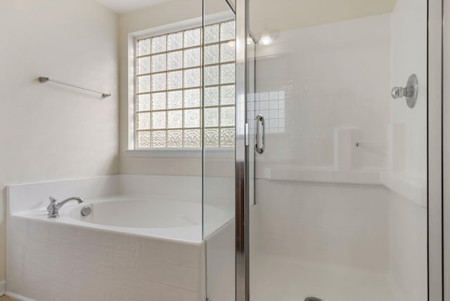 bathroom featuring plus walk in shower