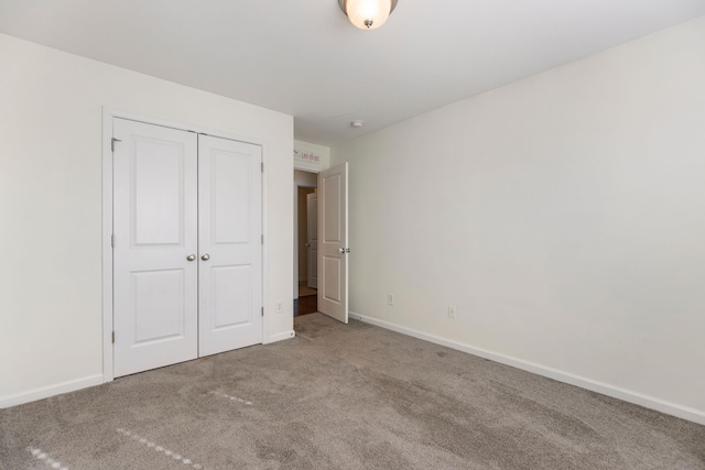 unfurnished bedroom with carpet floors and a closet