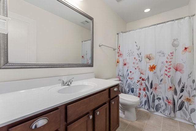 bathroom with tile patterned floors, vanity, and toilet